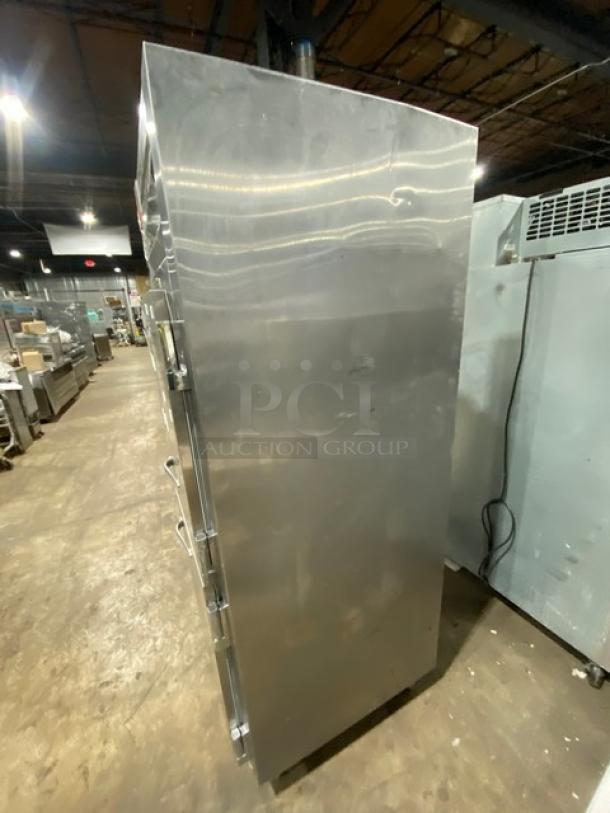 Traulsen RDT132WUT commercial stainless steel refrigerator/freezer combo with solid swing door, built-in pan slide, and chrome-plated wire rack.