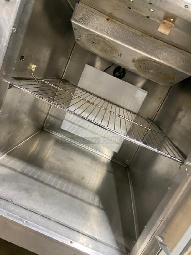 Traulsen stainless steel reach-in refrigerator/freezer interior, model RDT132WUT, with chrome rack, visible wiring, and pan slide.