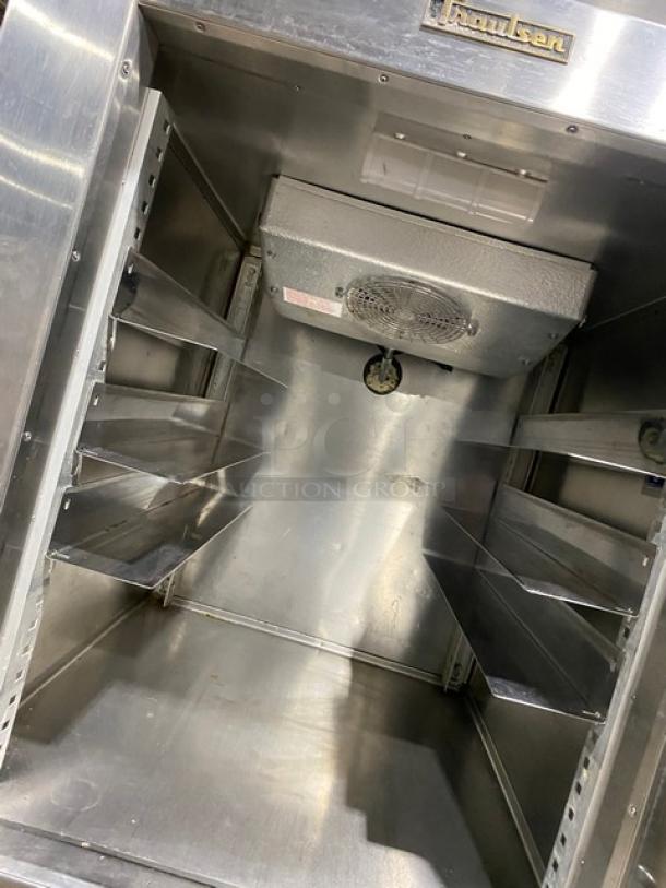 Traulsen stainless steel reach-in refrigerator/freezer, model RDT1-32WUT, with built-in pan slide and chrome rack, interior view.