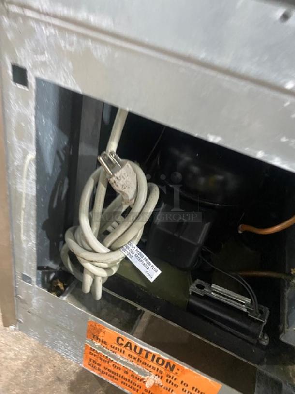 Duke Commercial Stainless Steel Worktop Refrigerator, Model RBC-60M, 120V, 1 Phase, includes power cord and safety warning label.
