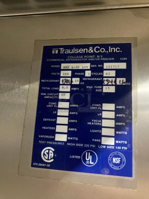 Traulsen RRI1-32LUT stainless steel roll-in refrigerator label; shows model, serial number 152717, 115V, 1 phase details.