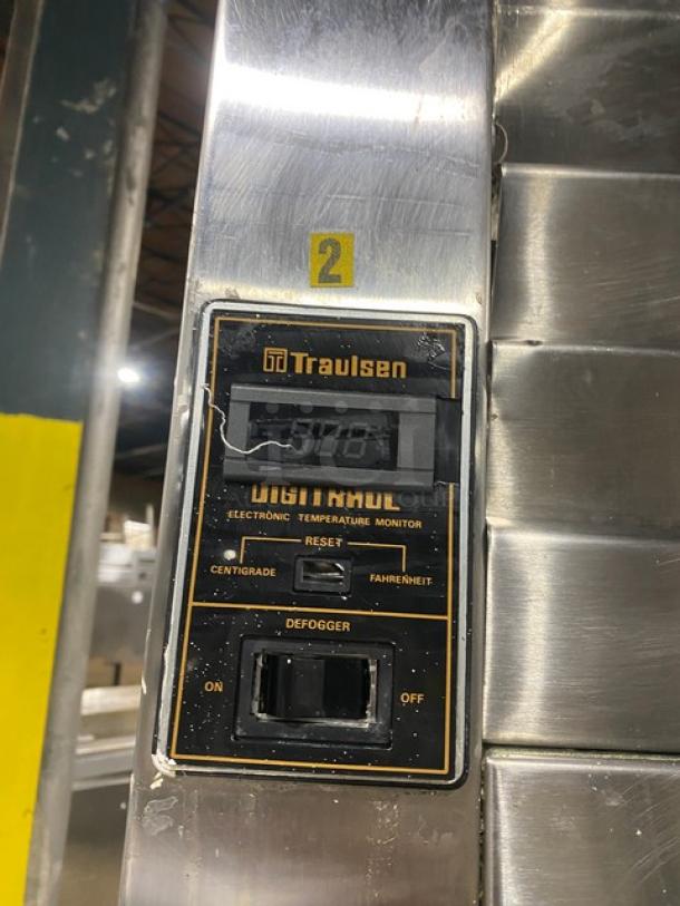 Traulsen commercial stainless steel roll-in refrigerator, model RRI132LUT, electronic temperature monitor visible, slight wear.