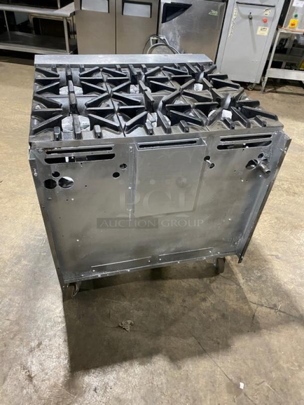 U.S. Range commercial stainless steel 6-burner gas range with enclosed cabinet-style storage base on casters.