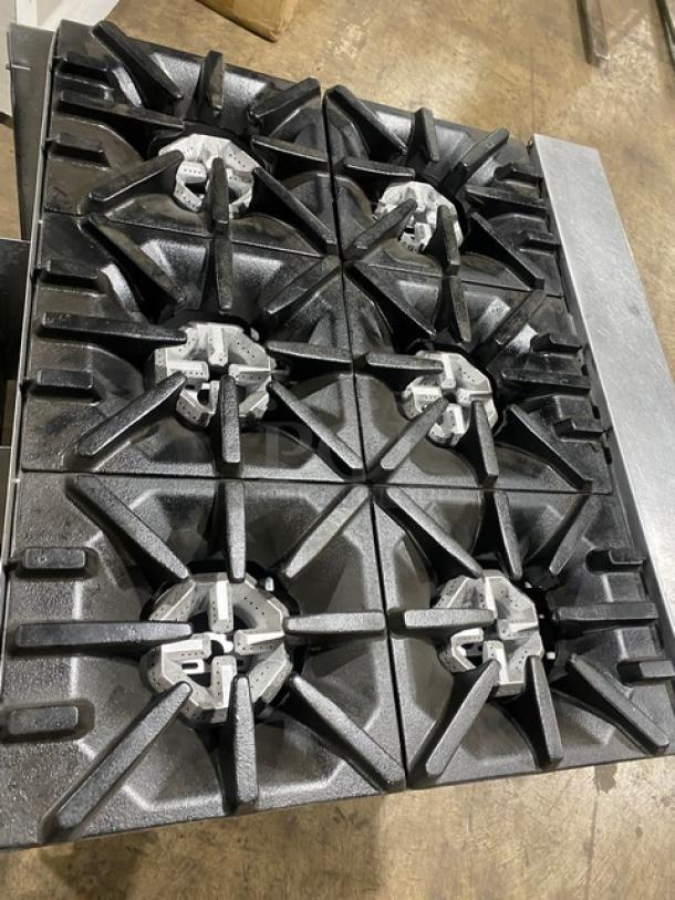U.S. Range commercial stainless steel 6-burner gas stove with enclosed cabinet and casters, in good condition.