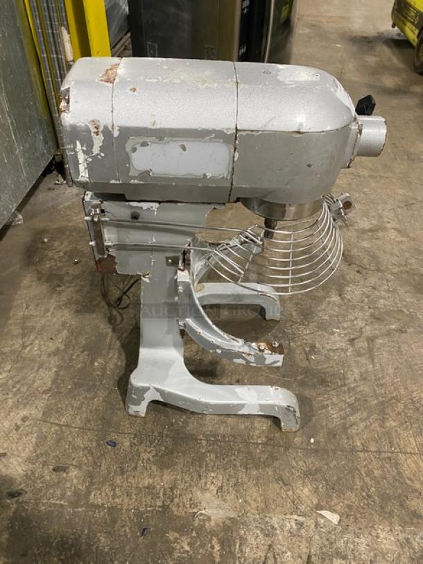 Commercial 20 Qt. Planetary Mixer VFM-20C, with stainless steel bowl guard, on legs, showing heavy wear and rust patches.