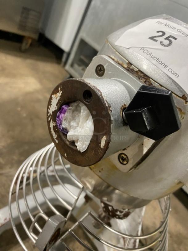 Commercial 20 Qt. VFM-20C planetary mixer with stainless steel bowl guard, 110V, visible wear, sturdy metal legs.