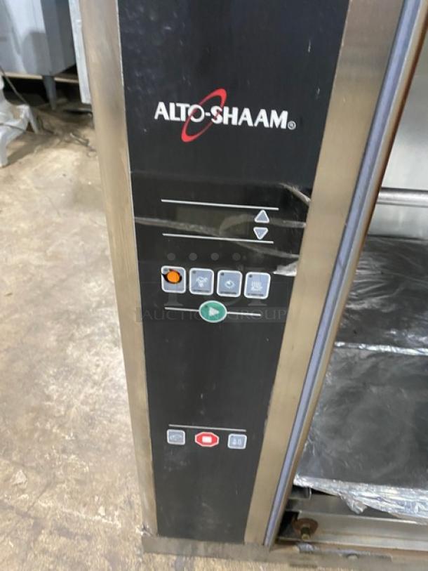 Alto-Shaam stainless steel electric countertop rotisserie oven with digital controls, visible wear on control panel.