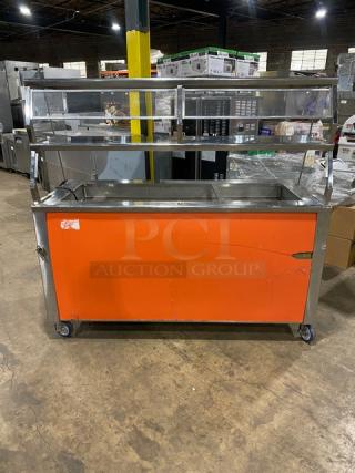 Precision stainless steel refrigerated salad bar, model SST-2024-RT-NYC, with sneeze guard, orange front, on casters.