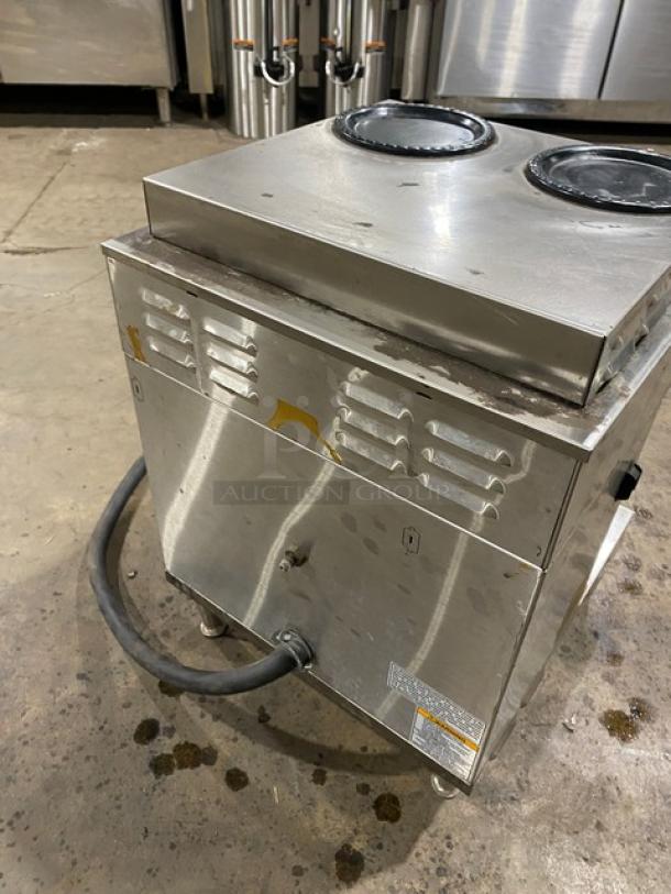 Bunn AXIOM22TWIN twin coffee brewer, stainless steel, 4 warming plates, digital controls, legs, fair condition, visible hose.