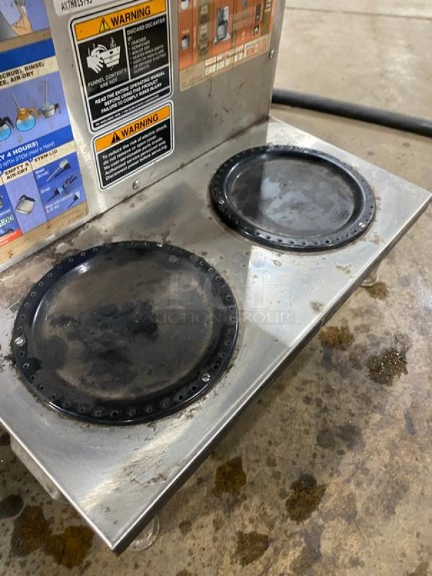 Bunn AXIOM2/2TWIN commercial coffee brewer with 4 warming plates, stainless steel, digital control, on legs, show wear.