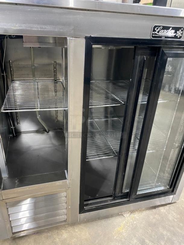 Leader LB48SC stainless steel 2-door refrigerated worktop lowboy with double glass sliding doors, chrome racks, and on casters.