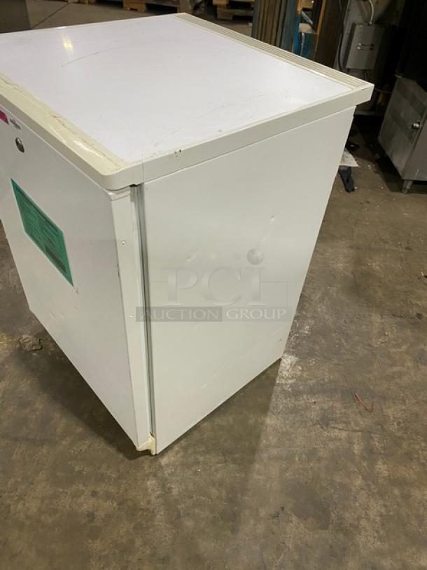 Fisher Scientific Model 979381 undercounter flammable storage unit, white, single door, poly-coated wire rack, used condition.