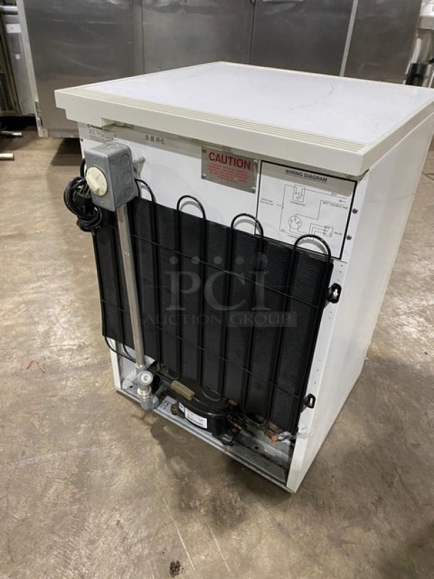 Fisher Scientific undercounter flammable materials storage unit, model 979381, with poly-coated wired rack, visible caution label.