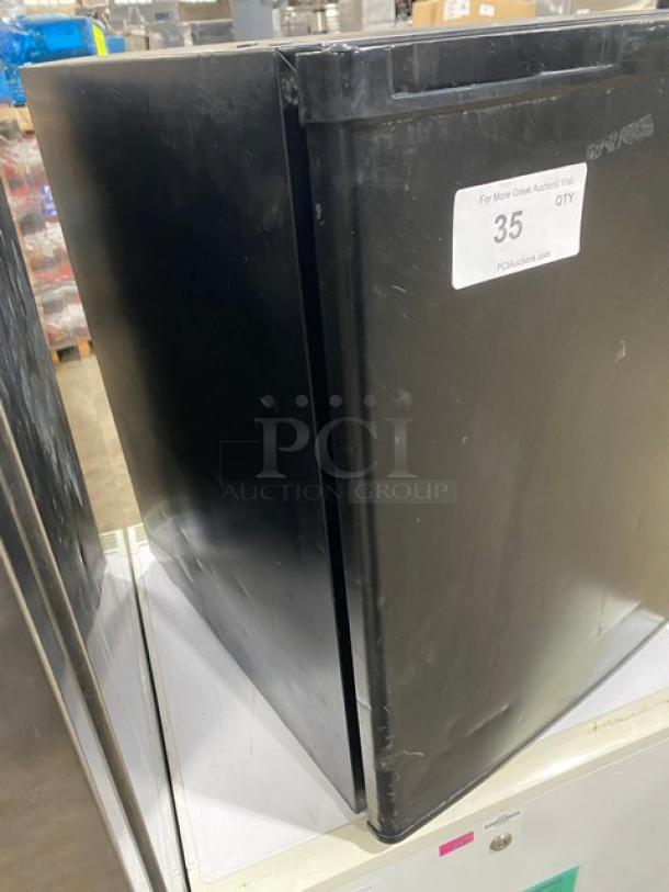 Antarctic BD60E compact upright freezer, black, single door, poly-coated wired rack, commercial model, 115V, visible scratches.