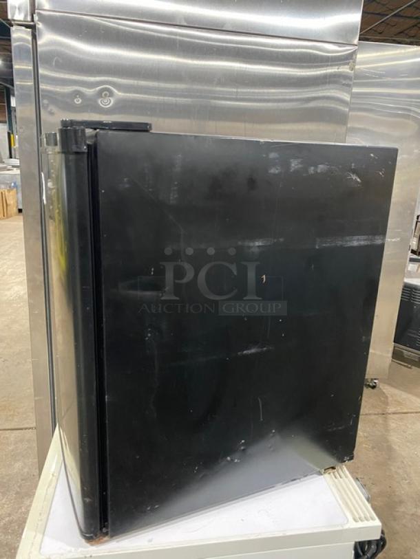 Antarctic BD60E compact upright freezer, black, single door, 2020 model. Includes poly-coated wired rack. Good condition.
