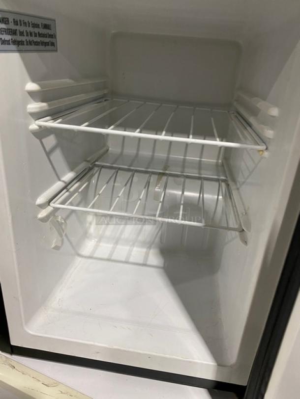 Antarctic BD-60-E single door upright freezer, black, with poly-coated wired rack. Model 2020, 115V, commercial-grade.