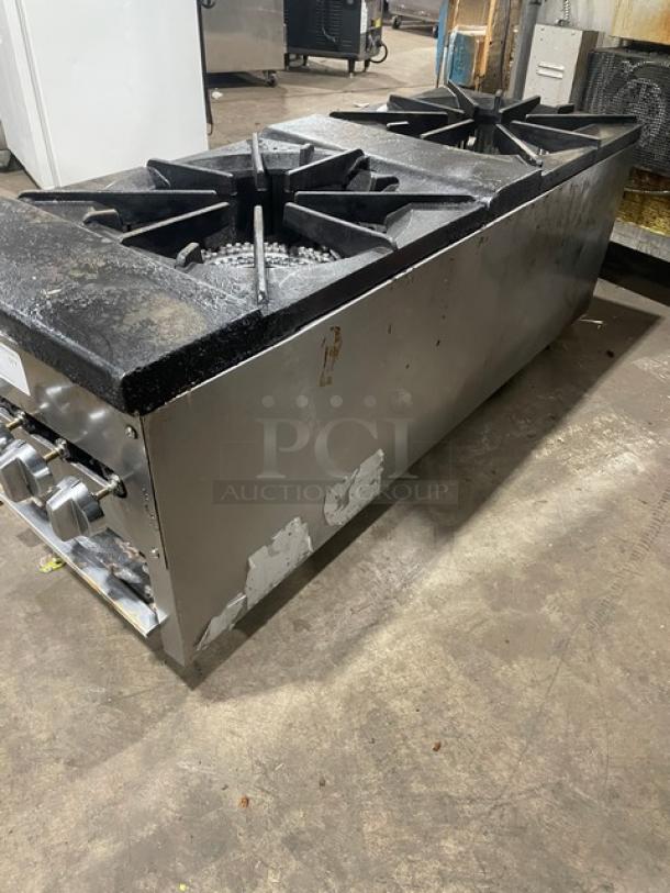 Cookline commercial stainless steel gas-powered double stock pot range with two front-to-back burners, on sturdy legs. Used condition.