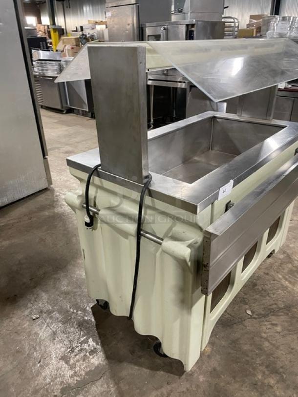 Custom buffet style stainless steel refrigerated cold food bar, with sneeze guard, folding tray slide, and casters.