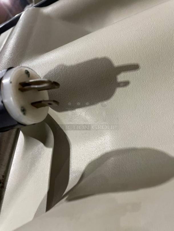 Close-up view of a plug from a stainless steel refrigerated cold food/salad bar, highlighting electrical compatibility.