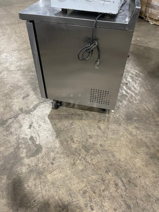 True TWT-72 commercial stainless steel 3-door worktop refrigerator with upturned backsplash, Energy Star certified, on casters.