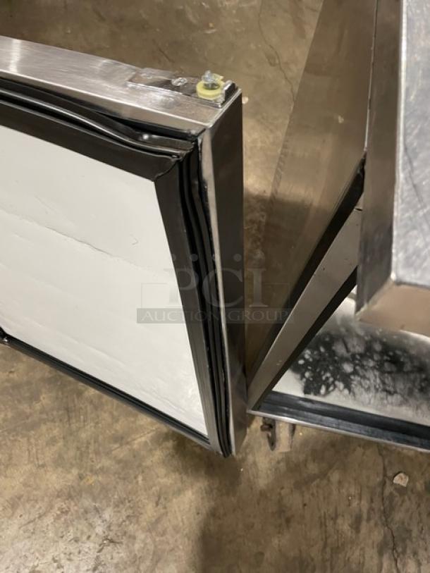 True TWT-72 stainless steel worktop refrigerator, 3-door, Energy Star certified, upturned backsplash, on casters, interior view.