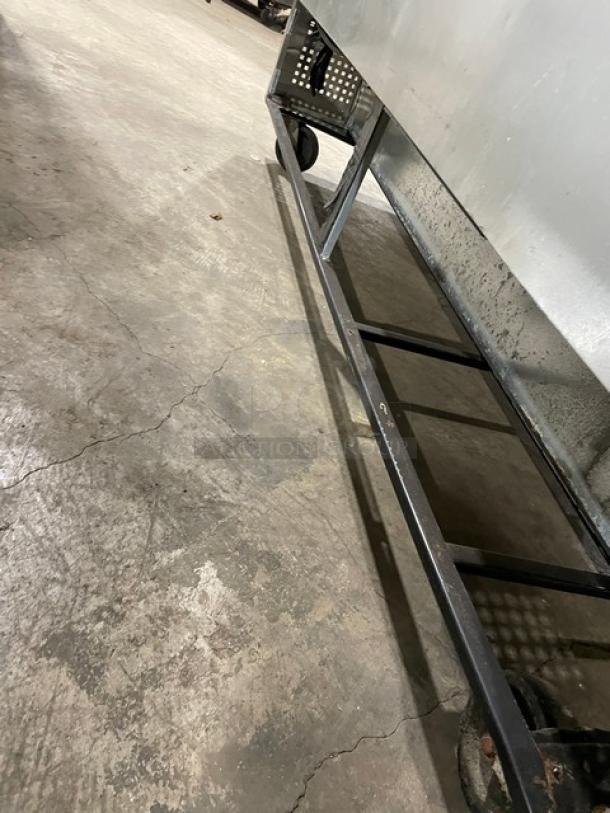 True TWT-72 stainless steel 3-door worktop refrigerator, Energy Star certified, with upturned backsplash, on casters.