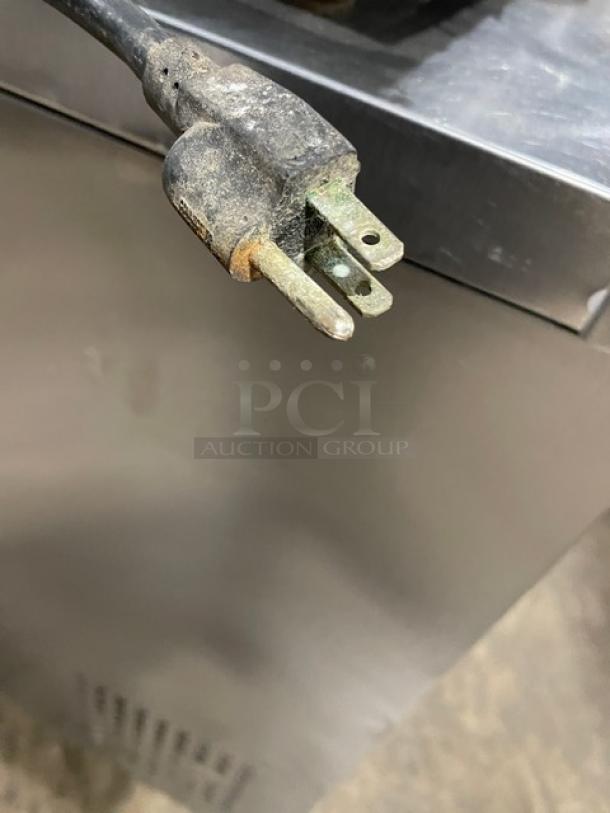 Cooler Depot stainless steel countertop ice cream batch freezer, Model BQL-112Y, electric-powered, 110V, on legs, visible wear.