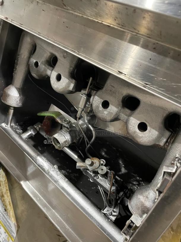 Commercial stainless steel gas fryer, countertop model, includes backsplash and fry basket, used condition.