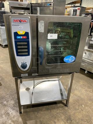 Rational SCC61 stainless steel combi convection oven, natural gas, 208V 3-phase, with single undershelf stand and wired oven rack.