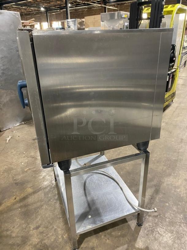 Rational SCC61 stainless steel commercial combi convection oven with undershelf stand and wired rack, natural gas powered, 208V 3 phase.