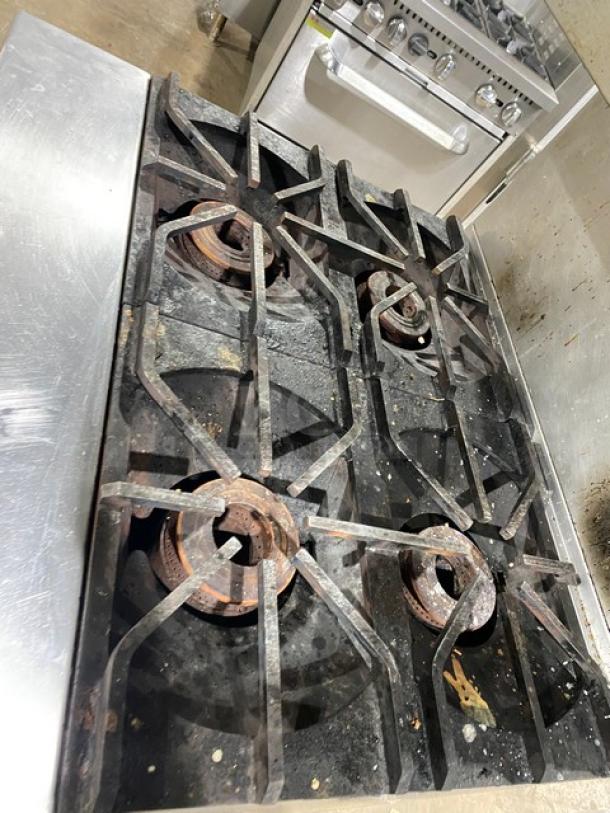 Blodgett B36C-XX commercial stainless steel 4-burner range with deck oven, undercounter storage, and backsplash. On casters.