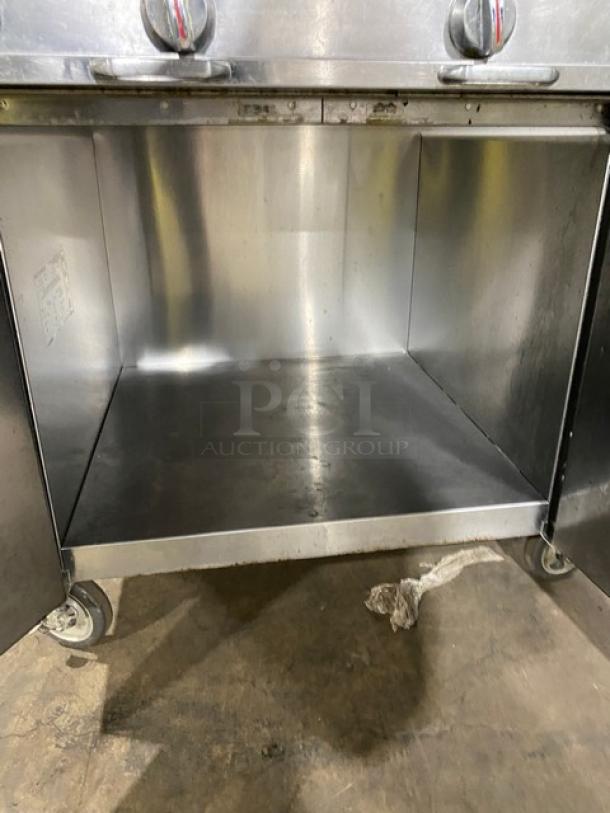 Blodgett B36C-XX range/oven combo, stainless steel undercounter storage, on casters. Clean interior, visible wear.