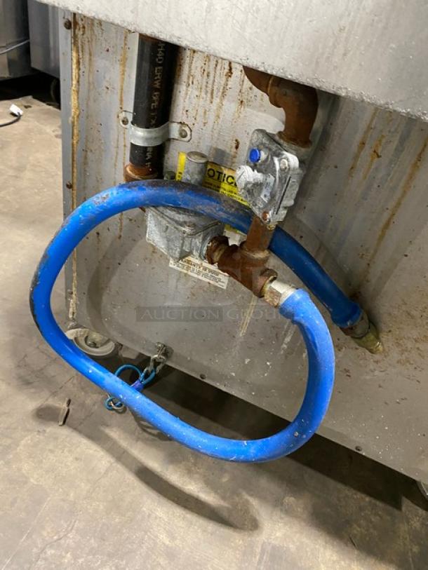 Blodgett commercial stainless steel gas-powered range/deck oven combo, Model B36C-XX, with undercounter storage, rear view showing gas connection and casters.