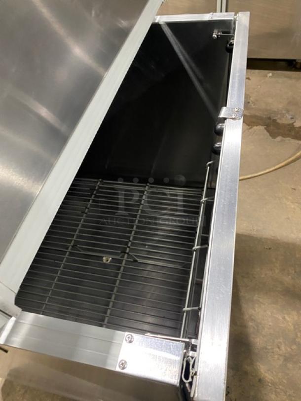 Beverage-Air SMF34 stainless steel milk cooler, electric-powered, single-access, on casters, shown open. Model SN: 5705447.