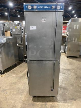 Alto-Shaam 1200-UP stainless steel dual-compartment heated holding cabinet on casters. Features individual compartment control and built-in universal rack. Model: 1200-UP SN: 171396-1101, 208-240V 1 Phase.