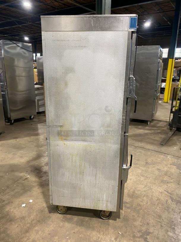 Alto-Shaam Halo Heat 1200-UP stainless steel dual-compartment heated cabinet, Dutch door, on casters, visible wear.