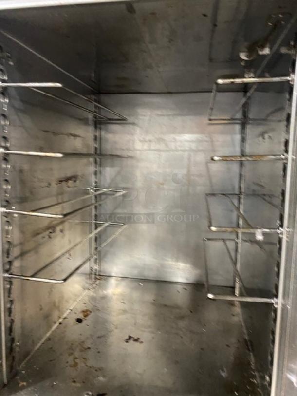 Alto-Shaam 1200-UP commercial stainless steel cabinet interior with adjustable racks and dual compartments on casters.