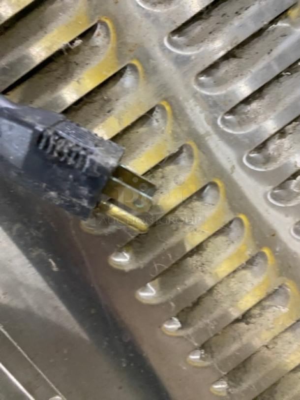 Close-up of a plug on Market Forge Eco-Tech Plus Series convection steamer, Model ETP10G. The surface shows dust accumulation.