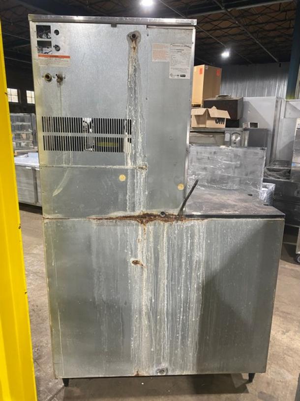 Hoshizaki KM-901MRH commercial ice machine and bin combo, stainless steel, electric powered, remote-cooled, on legs, visible rust and wear.