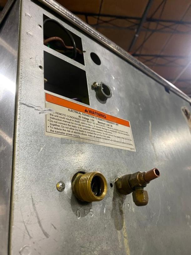 Hoshizaki KM-901MRH ice machine back panel with labels for electrical connections. Remote-cooled model, stainless steel exterior.