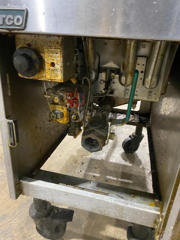 Pitco SG14S commercial stainless steel deep fat fryer, natural gas, 40 lb. capacity, on casters, includes backsplash.