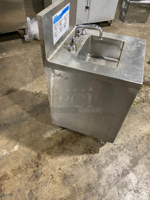 Ecolab commercial stainless steel hand washing station with swivel faucet, soap, and towel dispenser. Includes back splash and legs.