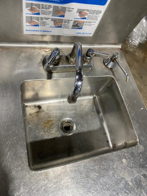 Ecolab stainless steel hand washing station with swivel faucet, soap & towel dispenser, backsplash, and legs. Slight wear visible.
