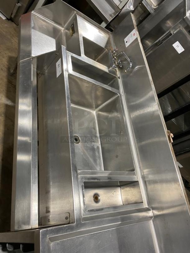 Commercial stainless steel cocktail station with back splash, integrated dump sink, swivel faucet, ice bin, speed rail, on legs.