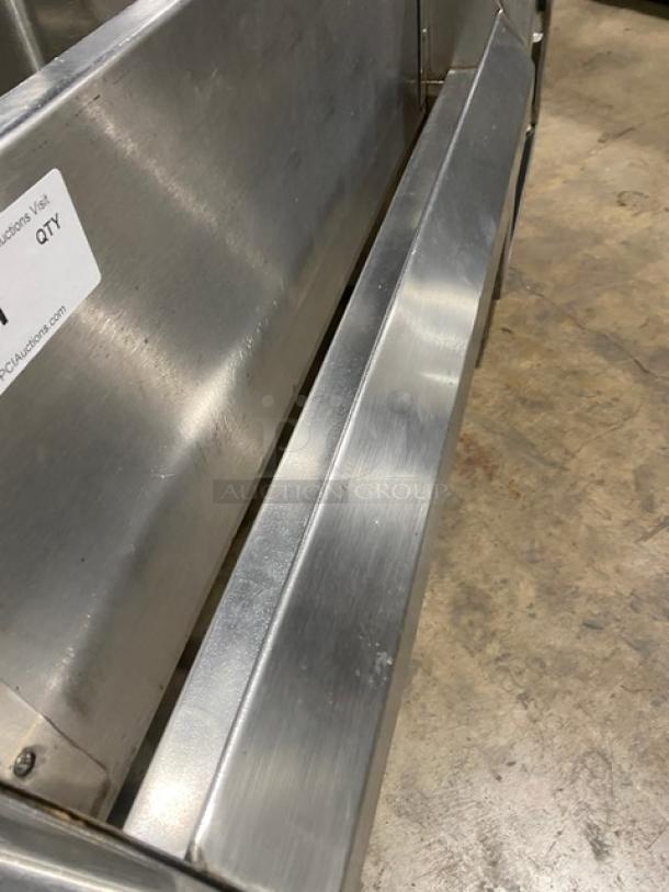 Commercial stainless steel cocktail station with backsplash, integrated dump sink, swivel faucet, ice bin, speed rail, on legs.