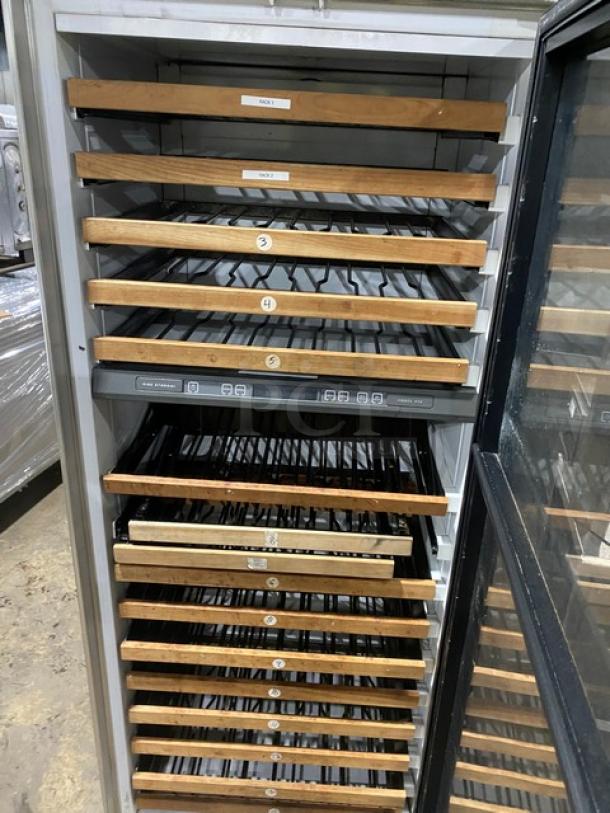 Sub-Zero stainless steel wine cooler, model 430, with a glass door and wooden shelves. Multiple storage levels.