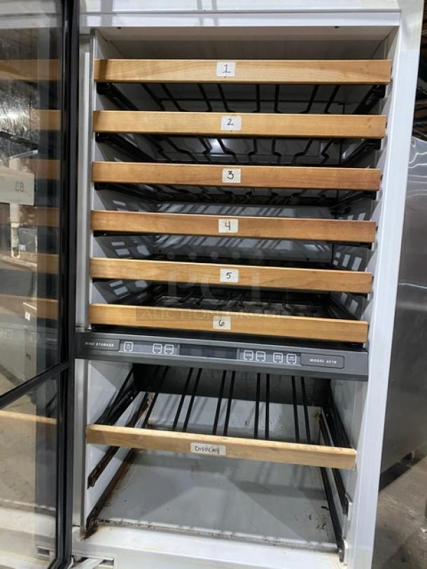Sub-Zero 427R refrigerated wine cabinet with glass door, wooden racks, and two-drawer storage base. Condition: good.