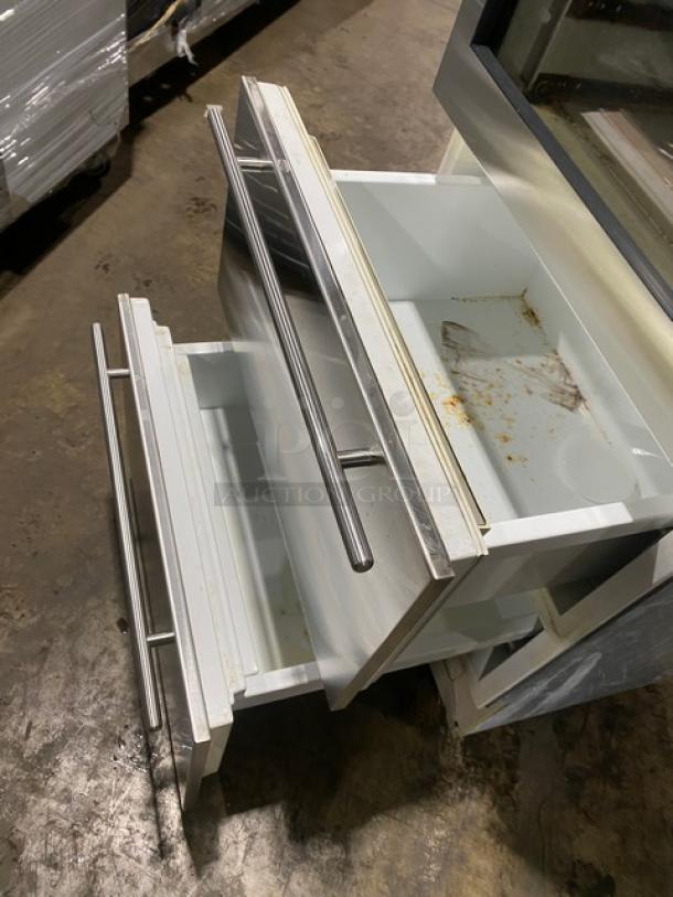 Sub-Zero 427R stainless steel wine storage cooler, glass swing door, 2-drawer base, visible wear inside drawers, commercial use.