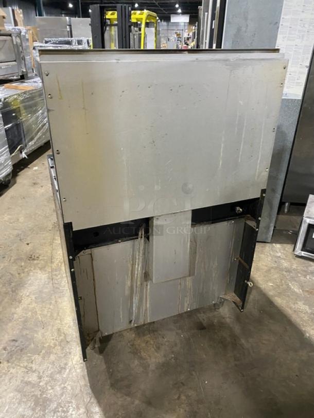 Garland stainless steel gas 6-burner range/oven, with back splash, overhead salamander shelf, wired oven rack, on legs, used.