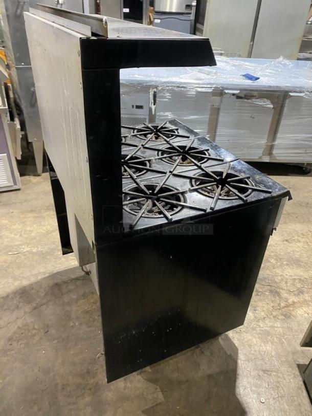 Garland stainless steel 6-burner range/oven with backsplash, overhead salamander shelf, wired oven rack, and legs. Gas powered.